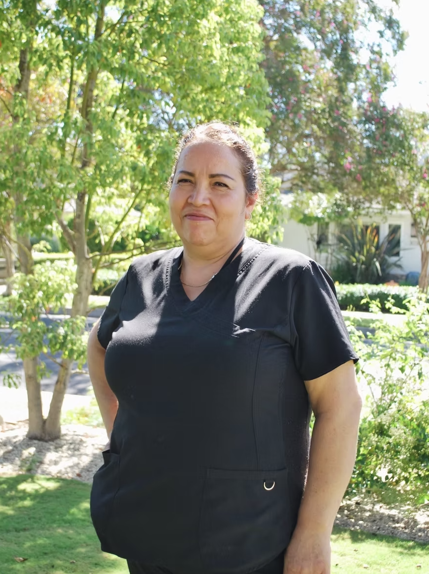 Kleen team member in uniform on a sunny lawn